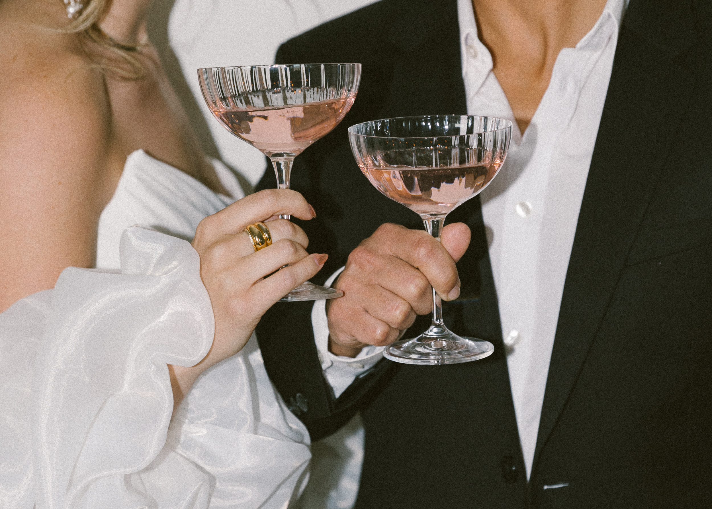 bride and groom holding champagne glasses after their elopement ceremony in joshua tree california