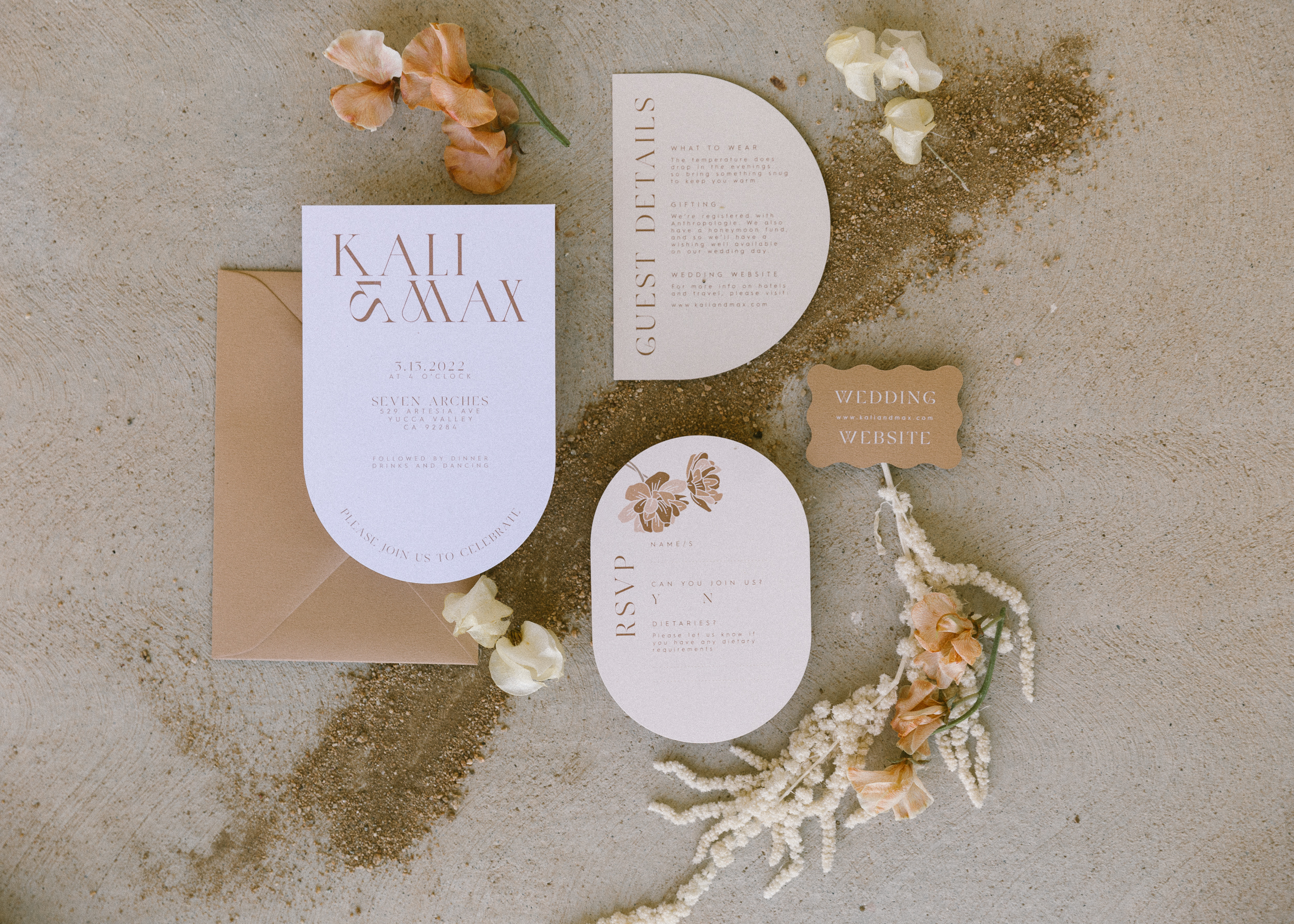 wedding invitations and florals set out in a flatlay image